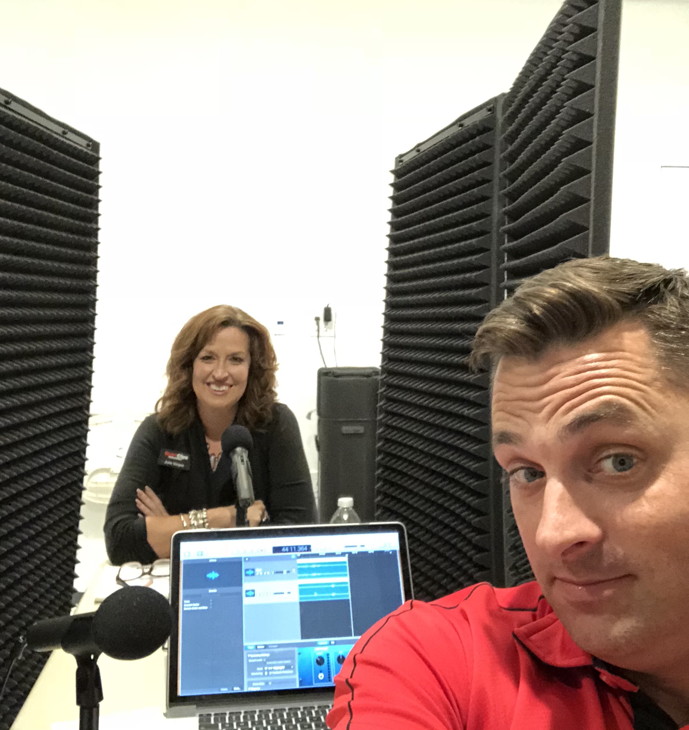 Julie Vargas and Chad Jordan at a table with microphones